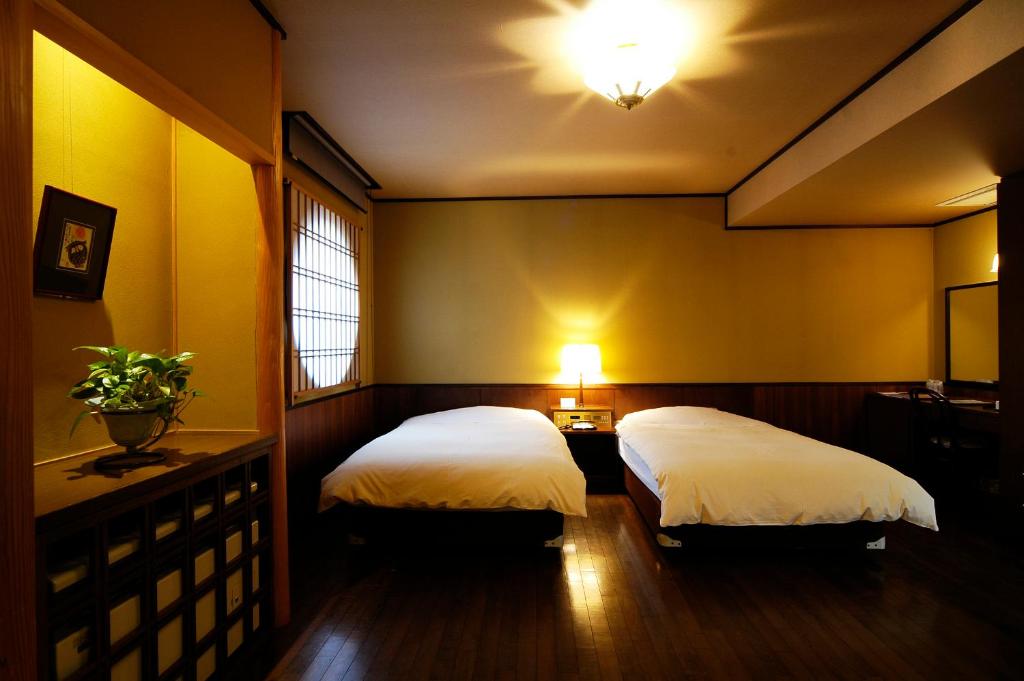 Postel nebo postele na pokoji v ubytování Hotel Kazahaya