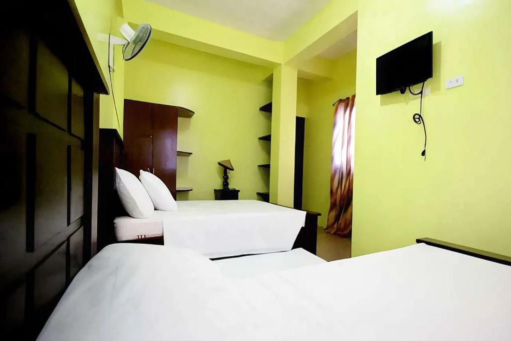 Postel nebo postele na pokoji v ubytování Luis Bay Travellers Lodge Coron