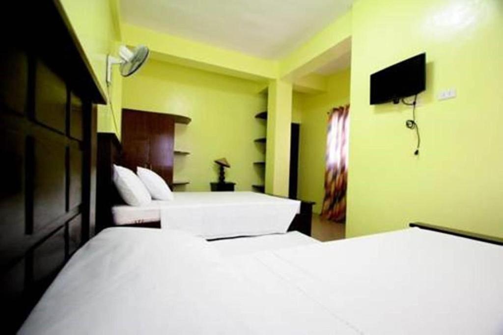 Postel nebo postele na pokoji v ubytování Luis Bay Travellers Lodge Coron