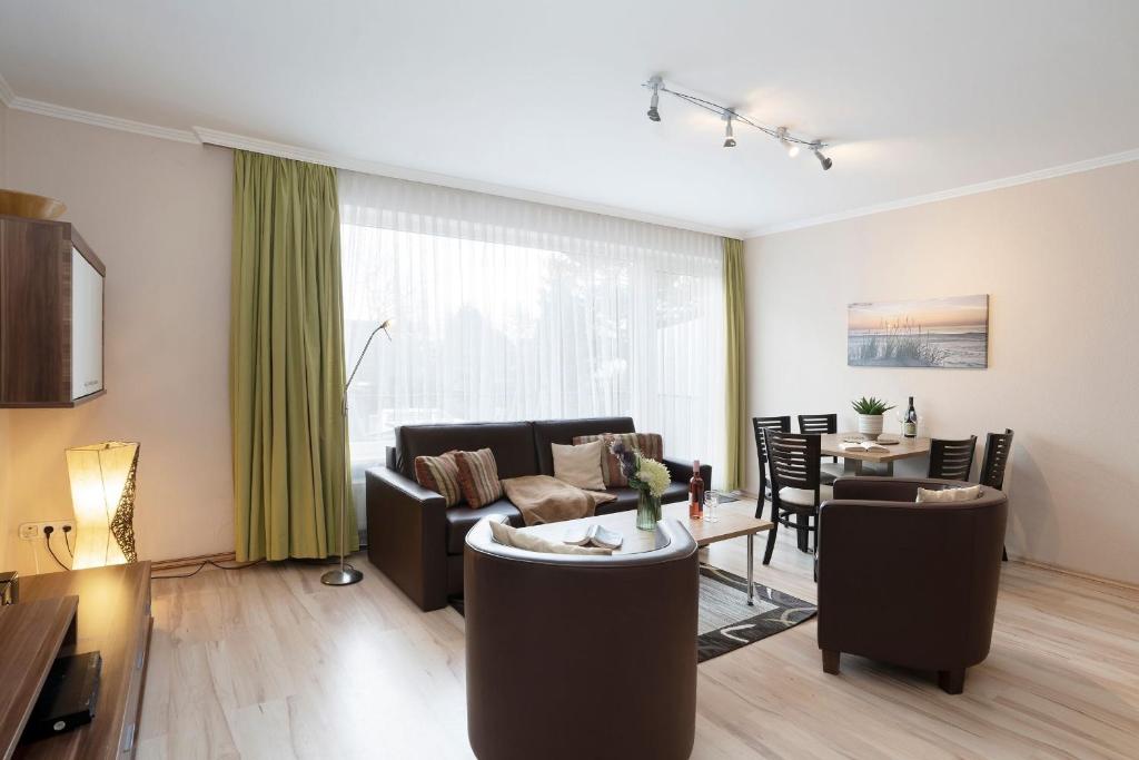 a living room with a couch and a table at Haus Baltic Ostseeidylle in Scharbeutz