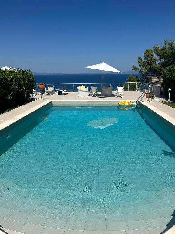 a large swimming pool with blue water at Villa Blue Lagoon in Afitos
