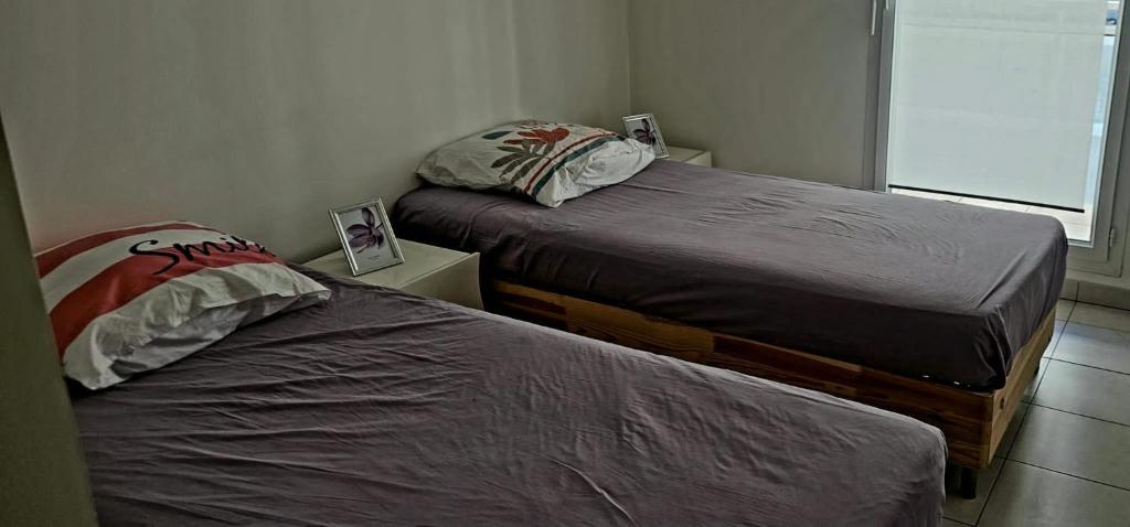 - 2 lits dans une petite chambre avec fenêtre dans l'établissement Palais Omnisports, appart 4 personnes lumineux avec terrasse, à Marseille