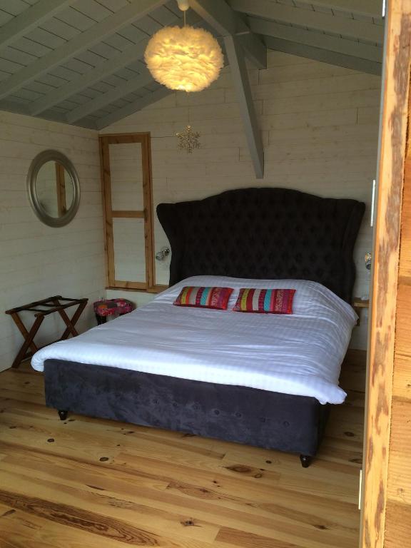 a bedroom with a large bed in a room at Cabane Perchée Spa Dordogne La Ferme de Sirguet in Monsac