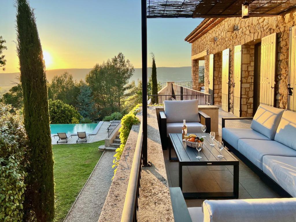 a patio with a couch and a table at provence living in Roussillon