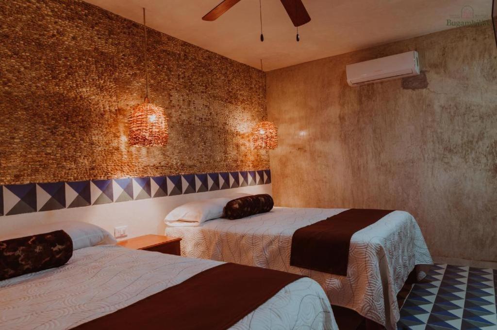 Postel nebo postele na pokoji v ubytování Hotel Boutique Bugambilias