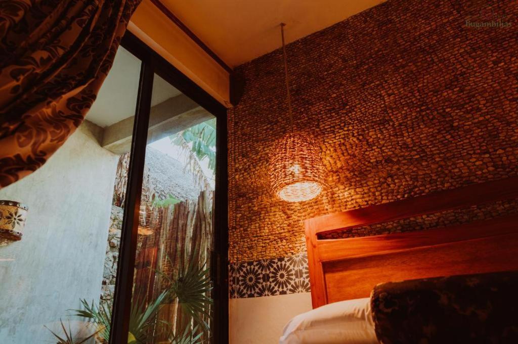 Postel nebo postele na pokoji v ubytování Hotel Boutique Bugambilias