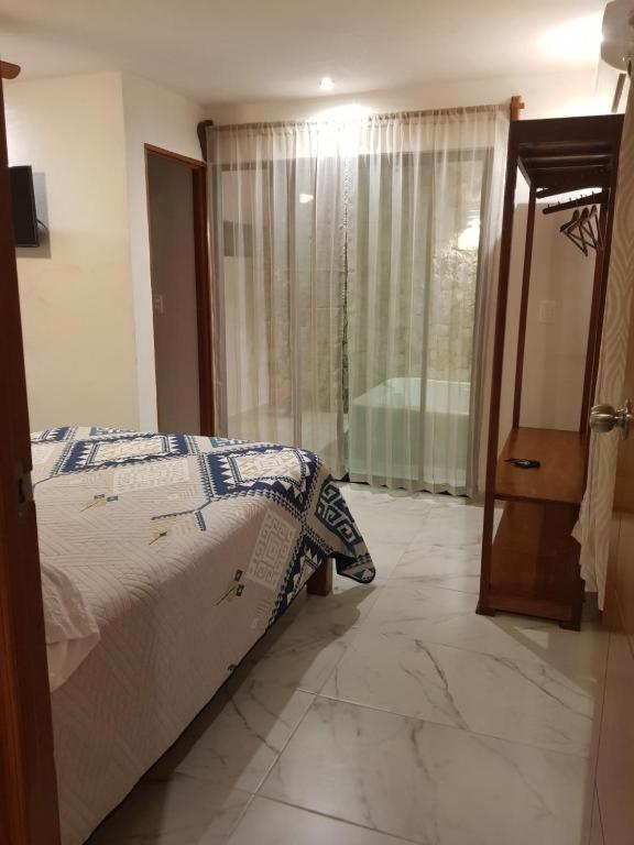 Postel nebo postele na pokoji v ubytování Hotel Boutique Bugambilias