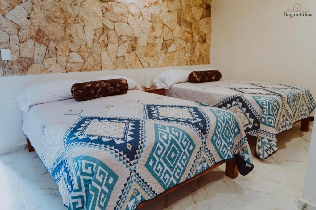 Postel nebo postele na pokoji v ubytování Hotel Boutique Bugambilias