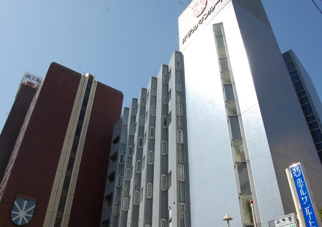 a tall building with a star on the side of it at Hotel Sunroute Aomori in Aomori