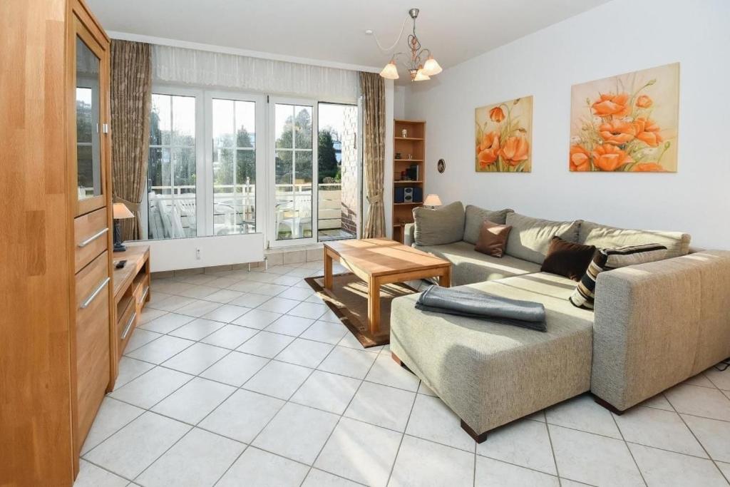 a living room with a couch and a table at Seepark Störtebekers Nest in Scharbeutz