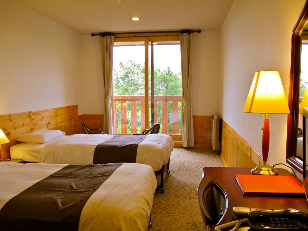 Postel nebo postele na pokoji v ubytování Hotel Andermatt