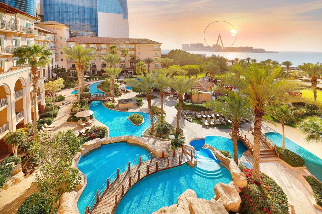 an aerial view of a resort with a water park at The Ritz-Carlton, Dubai in Dubai