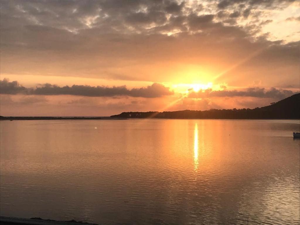 a sunset over a large body of water at Casa Foz do Rio in Caminha