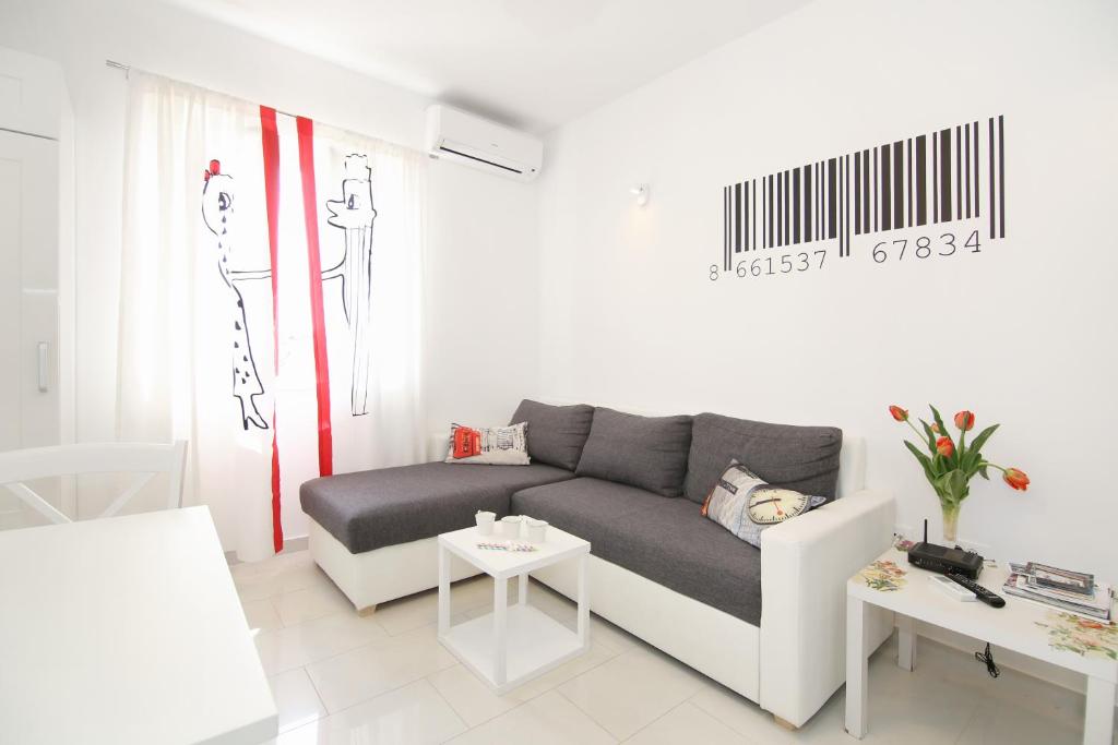 a living room with a couch and a table at Apartment LU in Split