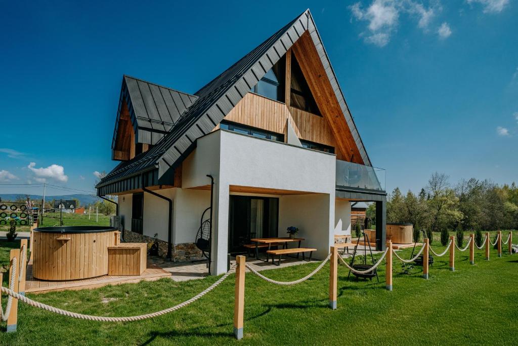 a house with a lot of ropes around it at Tatra Bliss Apartments- Białka Tatrzańska in Białka Tatrzanska