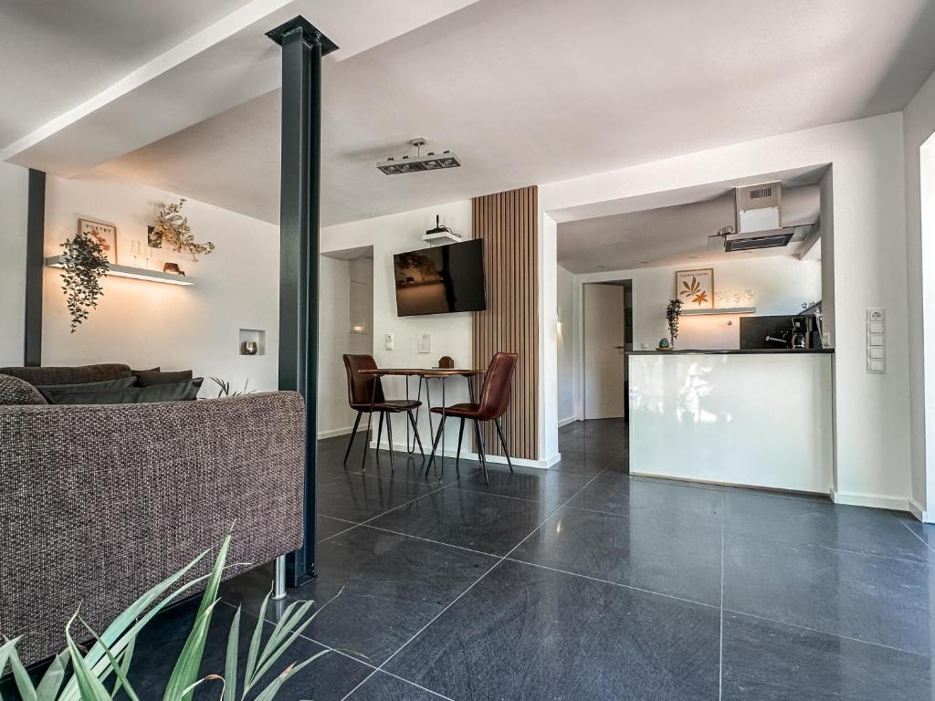 a living room and dining room with a table and chairs at Geschäfts- und Monteurs Apartment 2 SZ in Königswinter