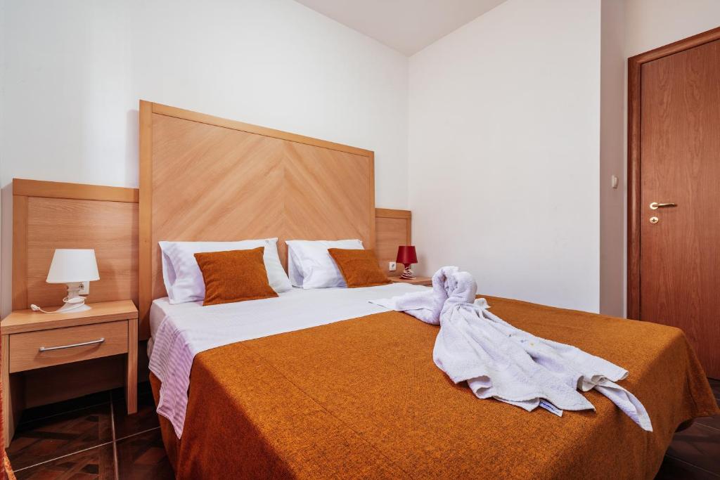 Postel nebo postele na pokoji v ubytování Apartments Radević
