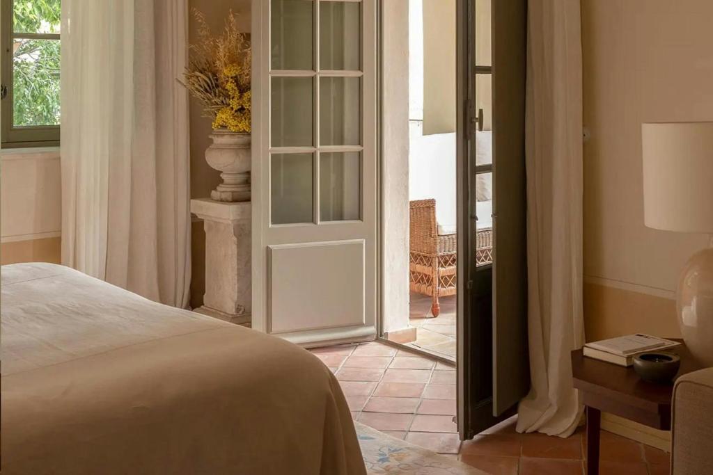 a bedroom with a bed and a door to a patio at Hôtel du Couvent, a Luxury Collection Hotel, Nice in Nice