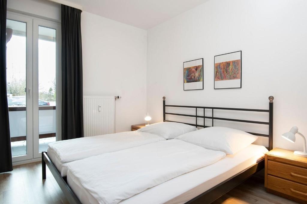 Postel nebo postele na pokoji v ubytování Strandhotel Kellenhusen Wohnung 3