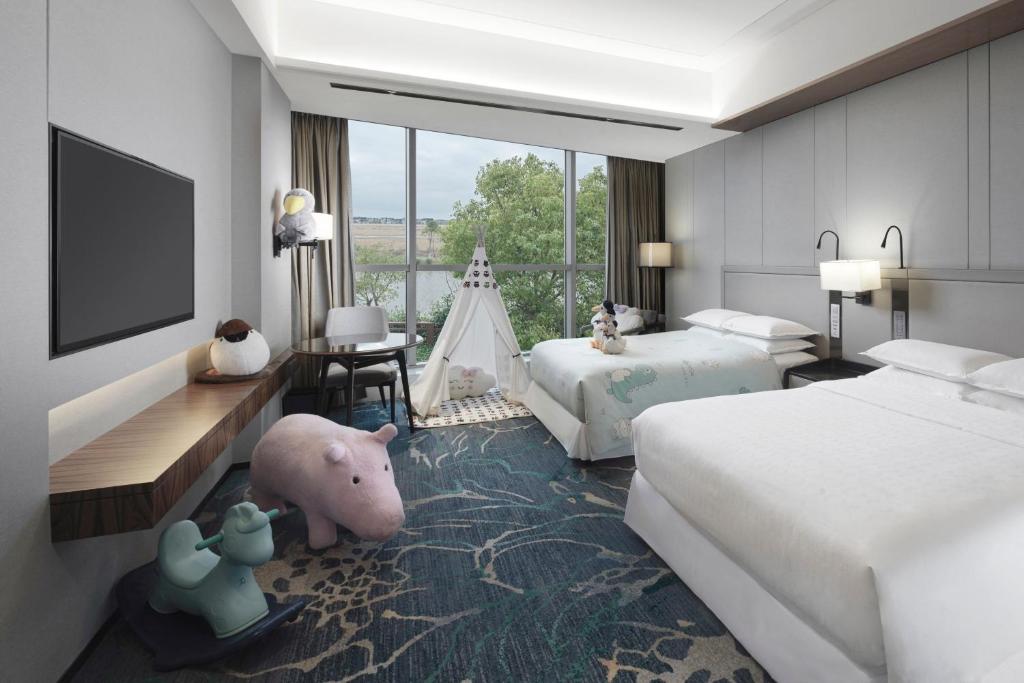 Postel nebo postele na pokoji v ubytování Sheraton Shanghai Chongming Hotel