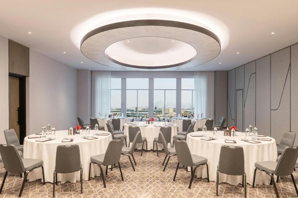 a conference room with tables and chairs and a large chandelier at Sheraton Mall of the Emirates Hotel, Dubai in Dubai
