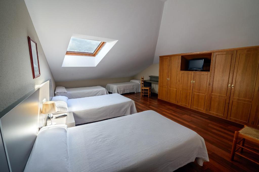 Postel nebo postele na pokoji v ubytování Hostal El Palacio