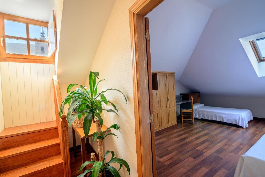 Postel nebo postele na pokoji v ubytování Hostal El Palacio
