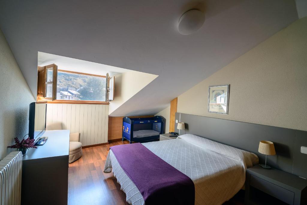 Postel nebo postele na pokoji v ubytování Hostal El Palacio
