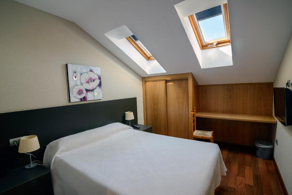 Postel nebo postele na pokoji v ubytování Hostal El Palacio