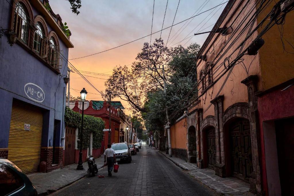 a man walking down a street in an alley at Mar de Lava in Mexico City