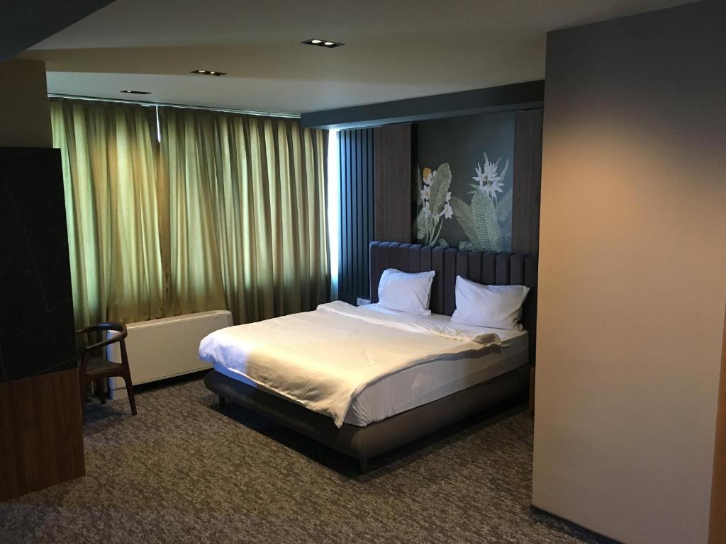 Postel nebo postele na pokoji v ubytování Hotel Emka