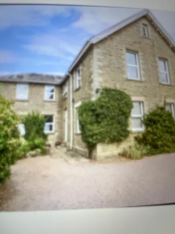 a large brick house with a driveway at Flat 2 Frank Lewis House in Hay-on-Wye