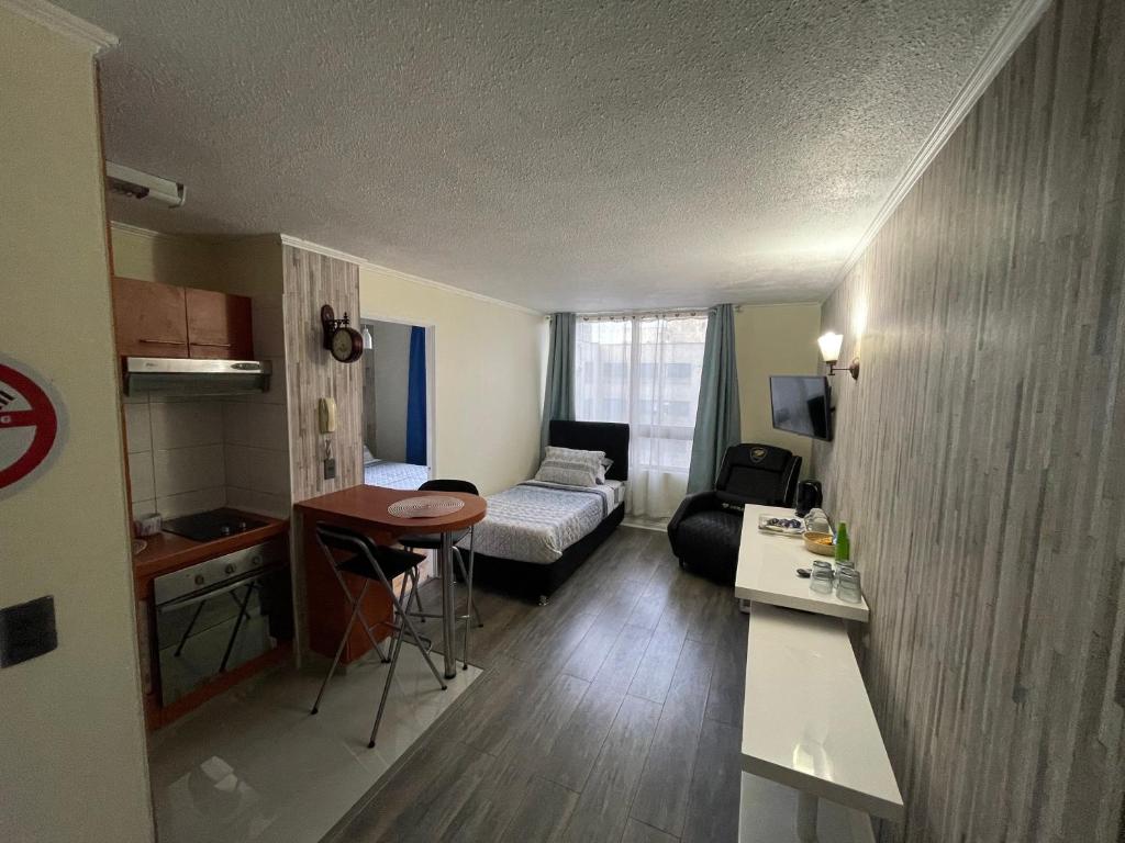 a small living room with a couch and a table at Apart Hotel "La Casa de Hersilia" in Santiago