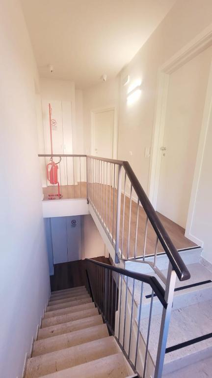 a staircase in a house with a stair case at Hotel Aurora Duino in Duino