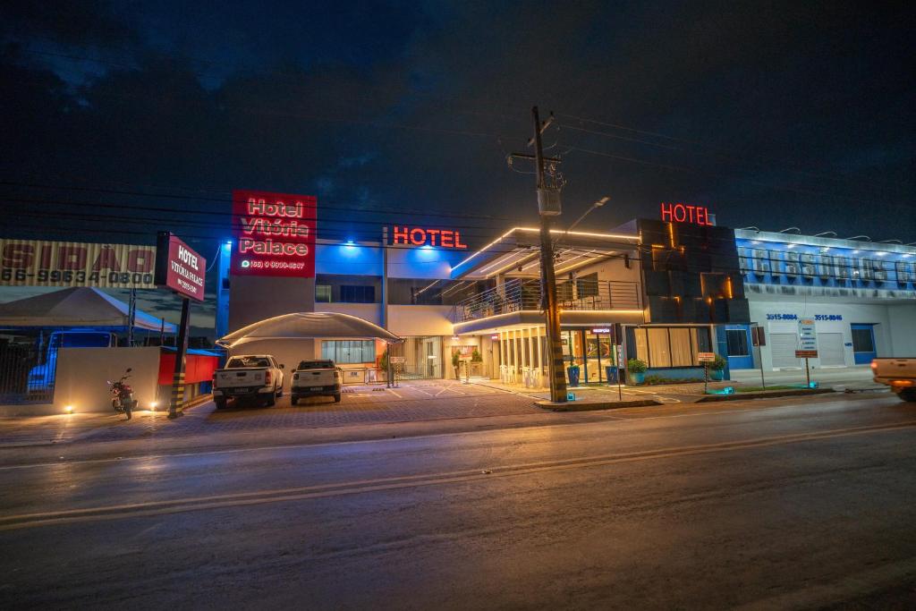 a street at night with cars parked in front of a hotel at Vitoria Palace Hotel in Sinop