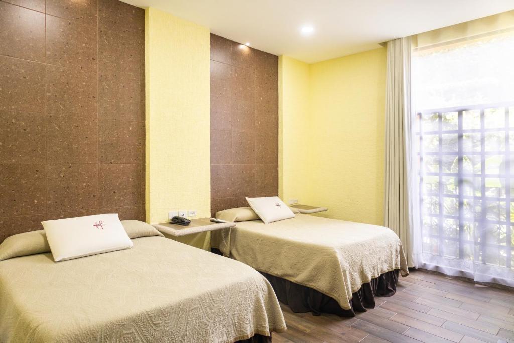 Postel nebo postele na pokoji v ubytování Hotel Fenix