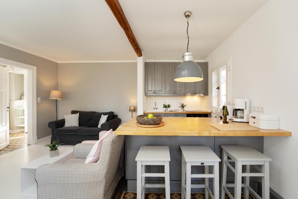 a kitchen and living room with a table and a counter at Weißes Haus 9123II in Fehmarn