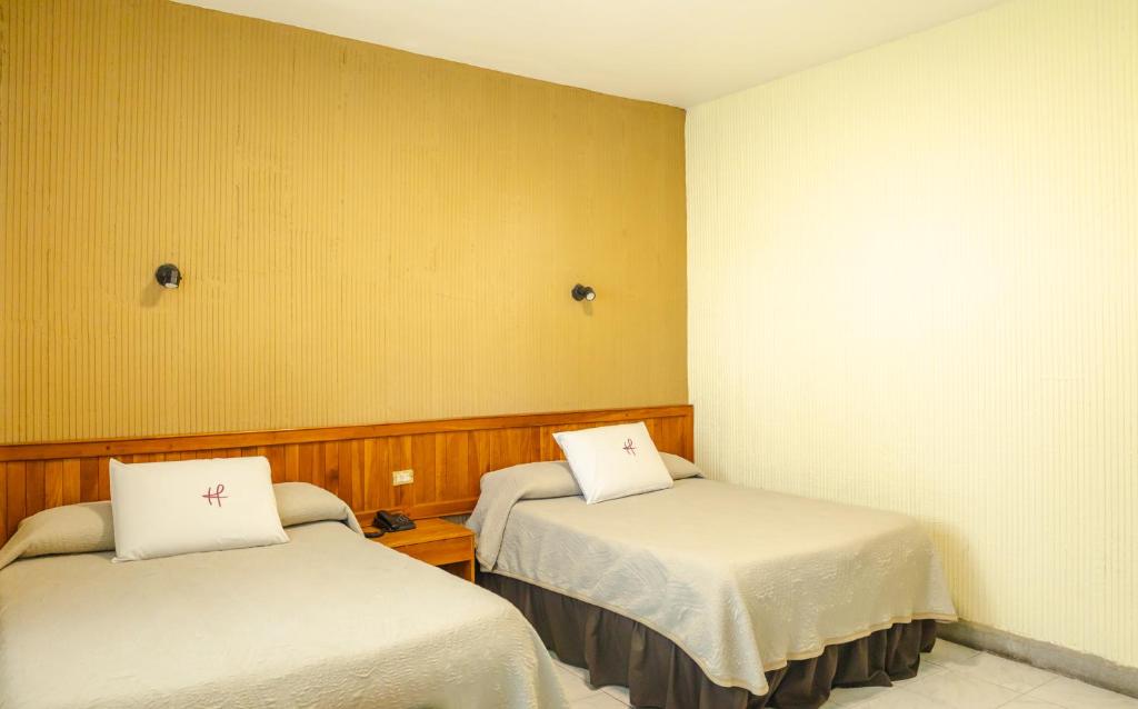 Postel nebo postele na pokoji v ubytování Hotel Fenix