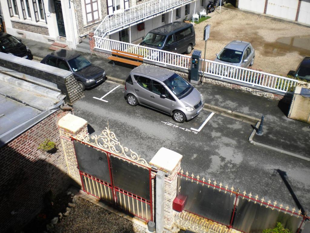 a car parked in a parking lot next to a building at Chambre D'hôte Villa Maurice in Étretat