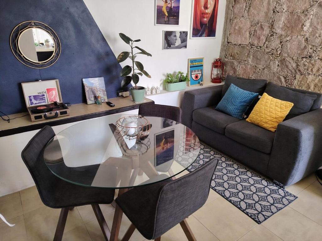 a living room with a glass table and a couch at Tiny House in Guanajuato