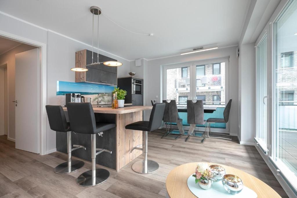 a kitchen and living room with a table and chairs at Lucia in Scharbeutz