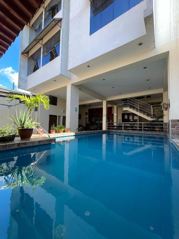 a swimming pool in front of a building at Hotel Luxor Pucallpa in Pucallpa