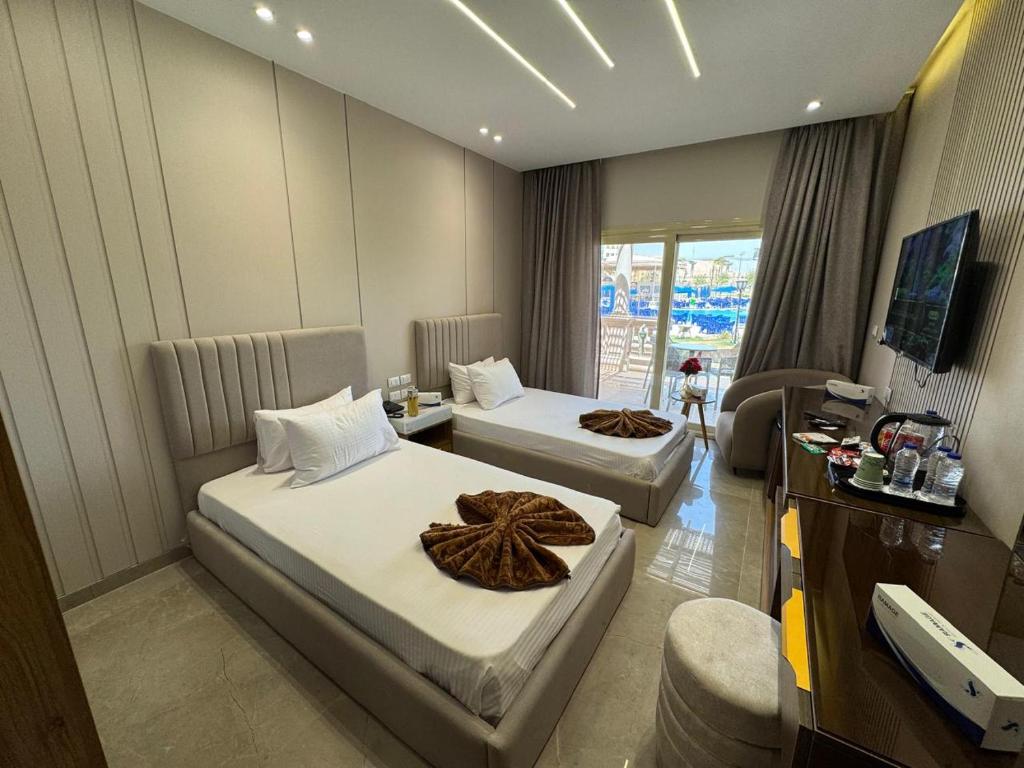 a hotel room with two beds and a television at Ramage Hotel & Resort in Cairo