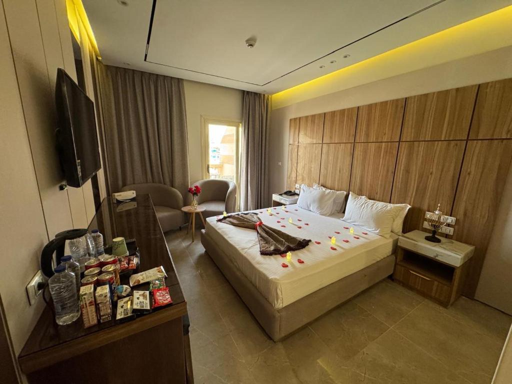 a hotel room with a bed and a television at Ramage Hotel & Resort in Cairo