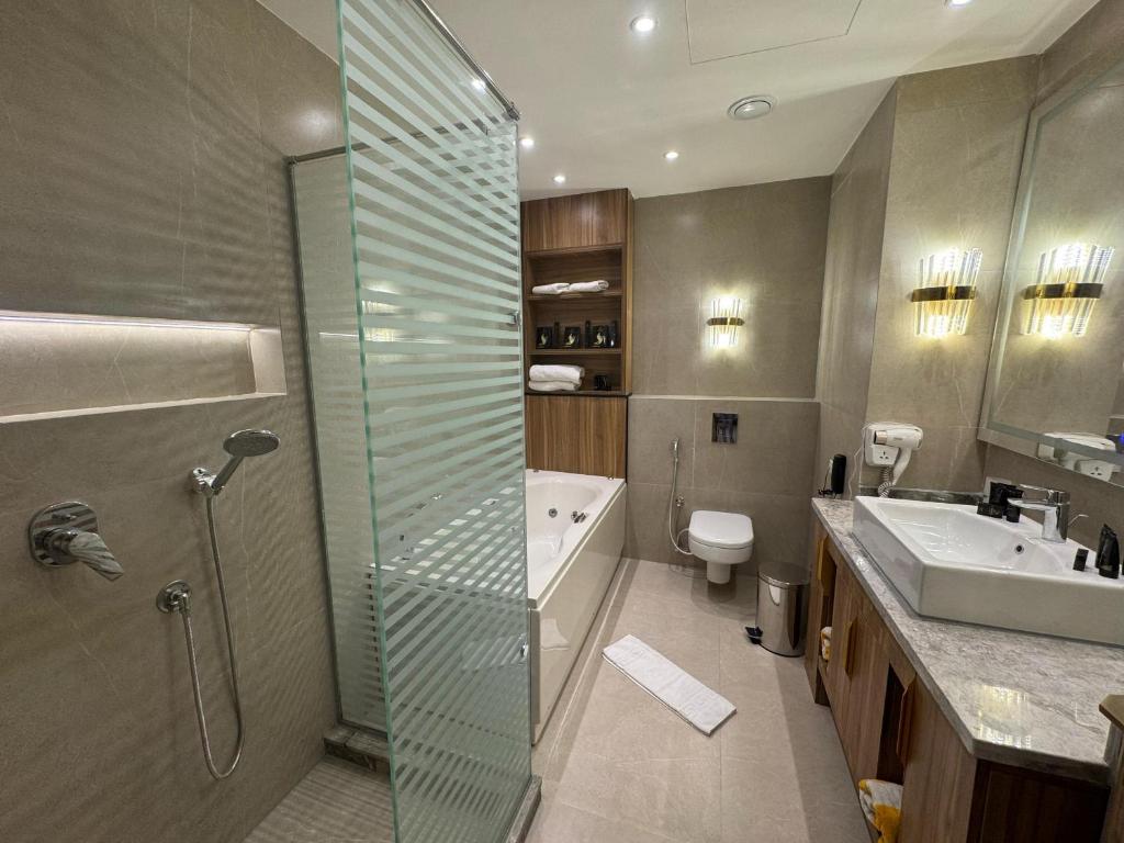 a bathroom with a shower and a sink and a toilet at Ramage Hotel & Resort in Cairo