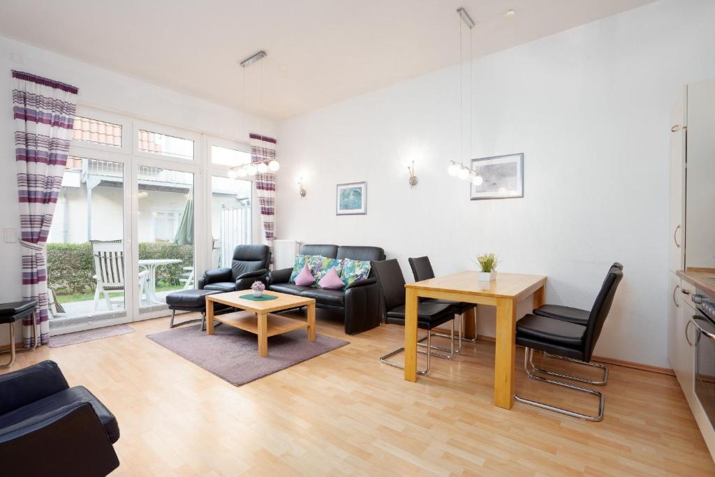 a living room with a couch and a table at Villa Olga Wohnung 3 in Grömitz
