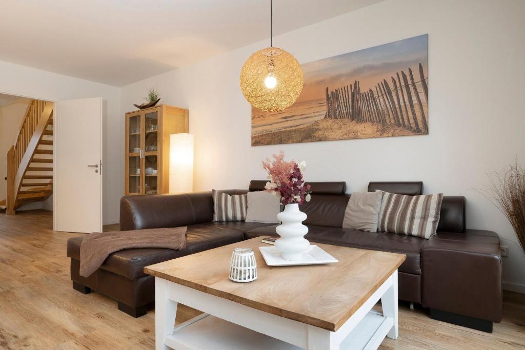 a living room with a couch and a table at Ferienhaus Salomons Sonne in Kellenhusen