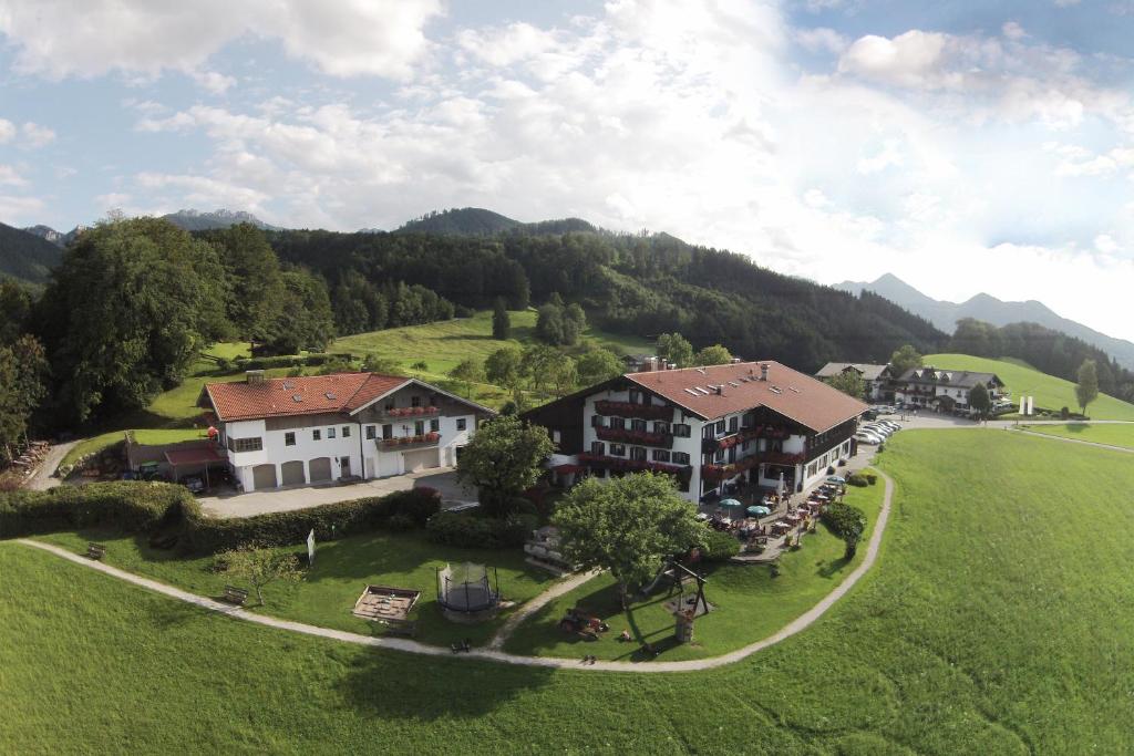 an aerial view of a house in a green field at Hotel Seiserhof & Seiseralm in Bernau am Chiemsee