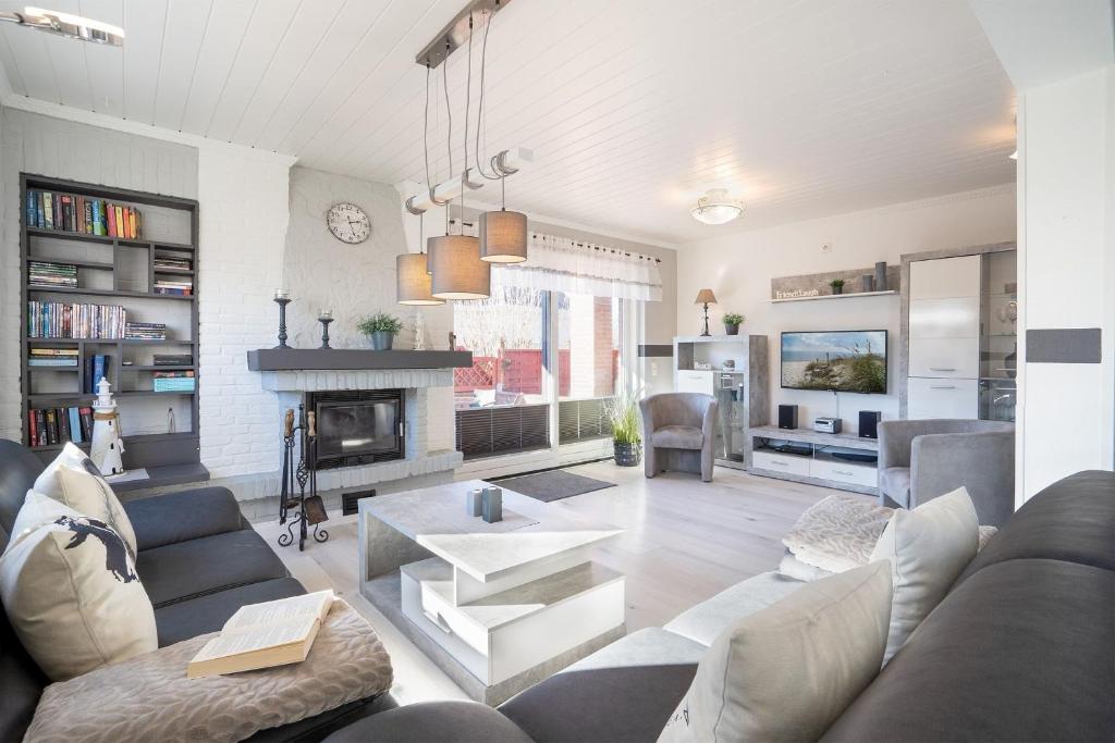 a living room with a couch and a fireplace at Ostseestern in Grömitz