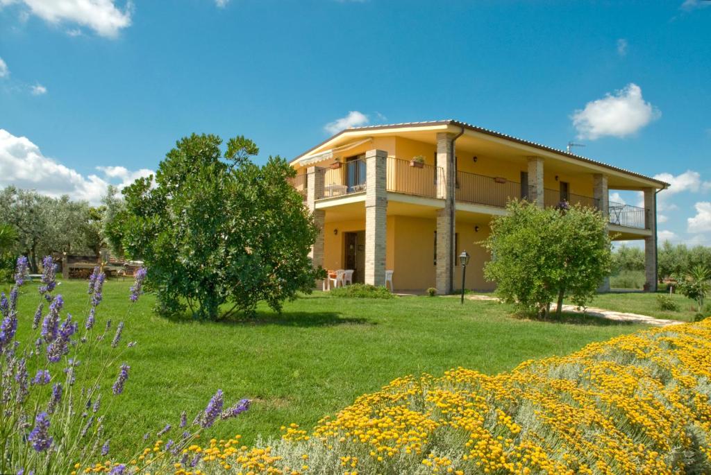 a house with a field of flowers in front of it at Villa Martina in Vasto